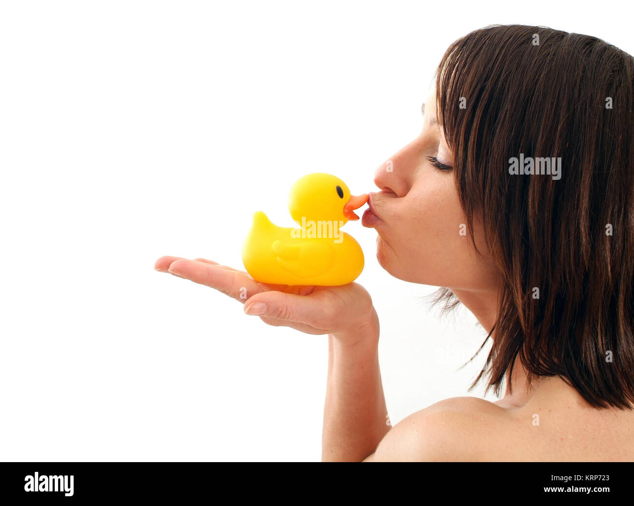 Junge Frau kuesst Badeente - young woman kissing rubber duck Stock Photo