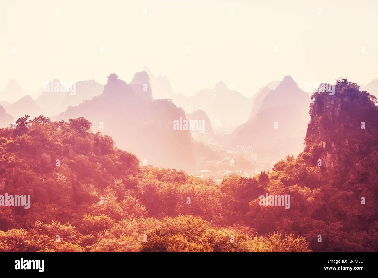 Karst mountainous landscape at sunrise, color toned picture, Guilin, China. Stock Photo