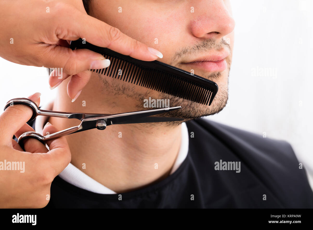 Hairdresser Shaping Man's Beard With Scissor And Comb Stock Photo Alamy