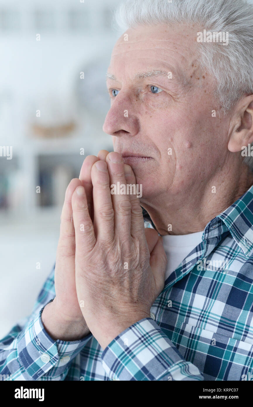 senior man praying Stock Photo