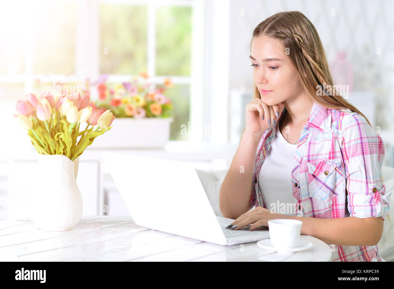 Teen girl using laptop Stock Photo