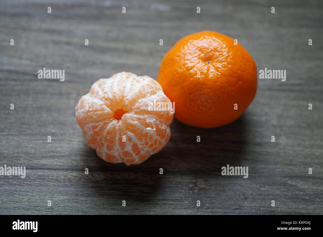 clementines or tangerines or mandarin oranges on rustic wooden table Stock Photo