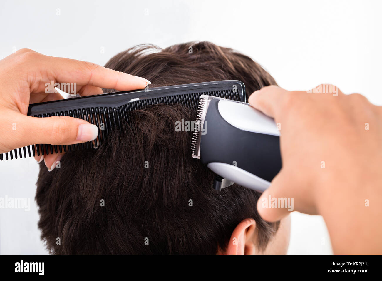 Hairdresser Cutting Man's Hair With Electric Trimmer Stock Photo Alamy