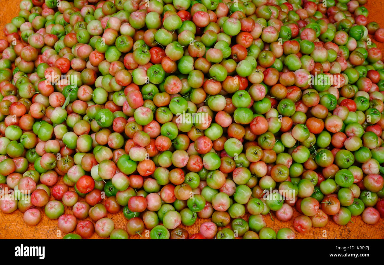 Malpighia glabra (red acerola) tropical fruits at local market Stock Photo