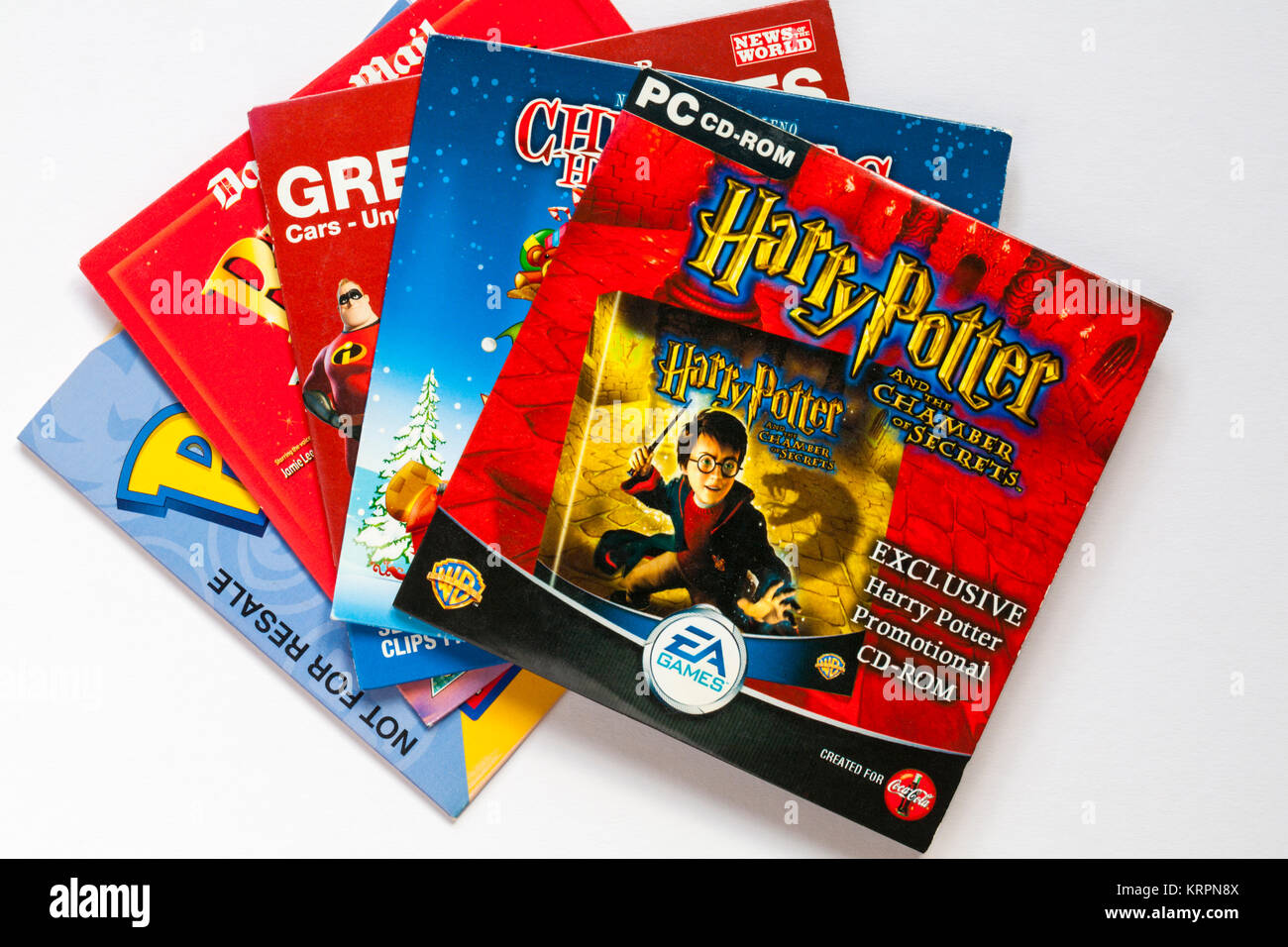 Selection of children's discs with Harry Potter and the Chamber of Secrets PC CD-ROM on top set on white background Stock Photo