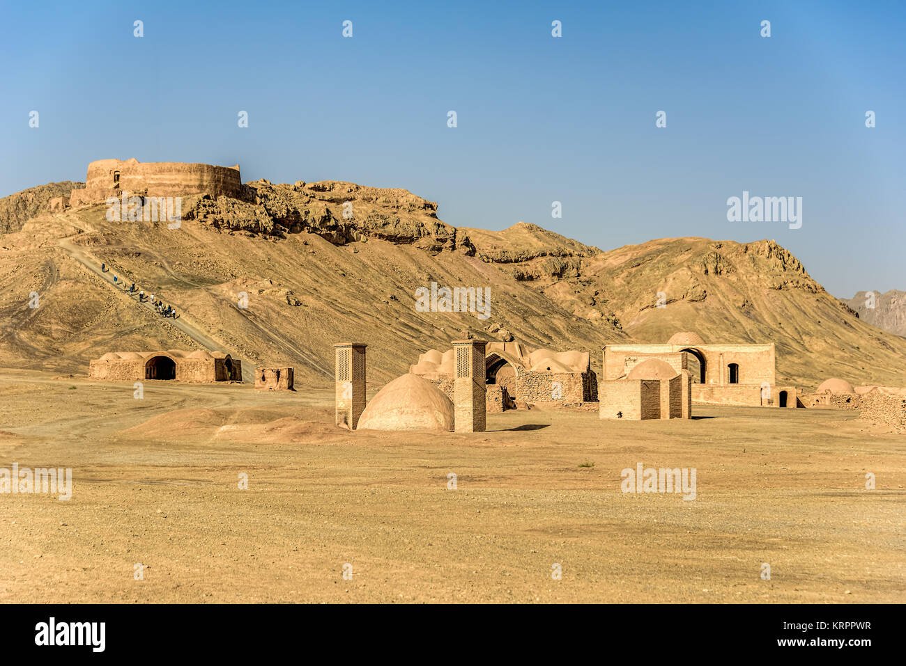 Towers of silence in a barren desert under clear blue skies Stock Photo