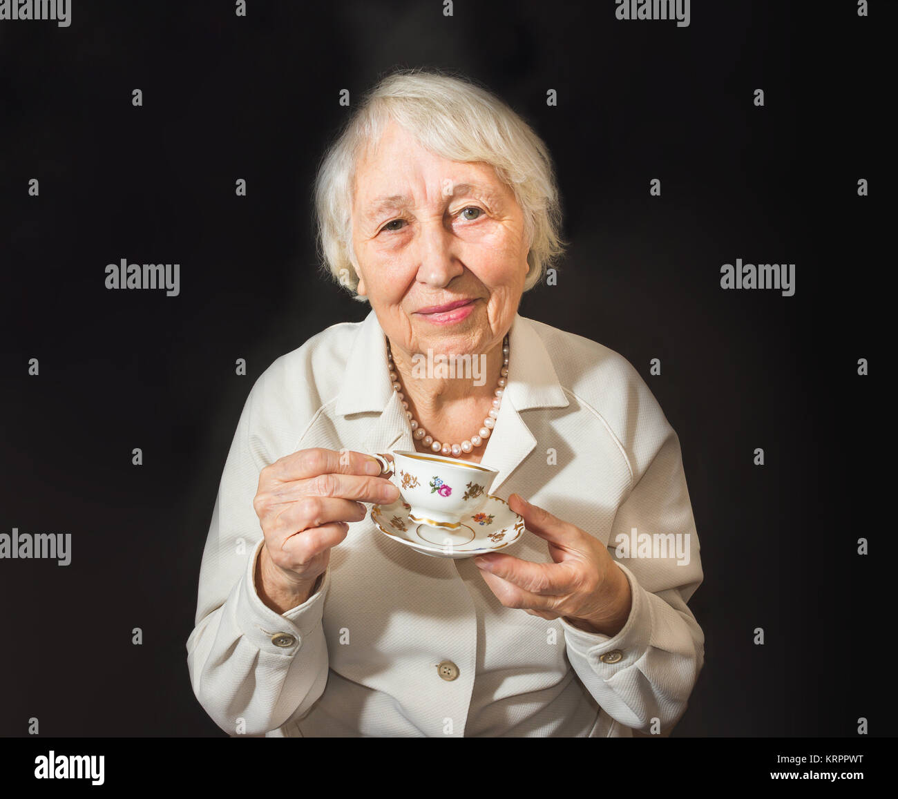 Senior Woman Enjoying Cup Of Tea Stock Photo