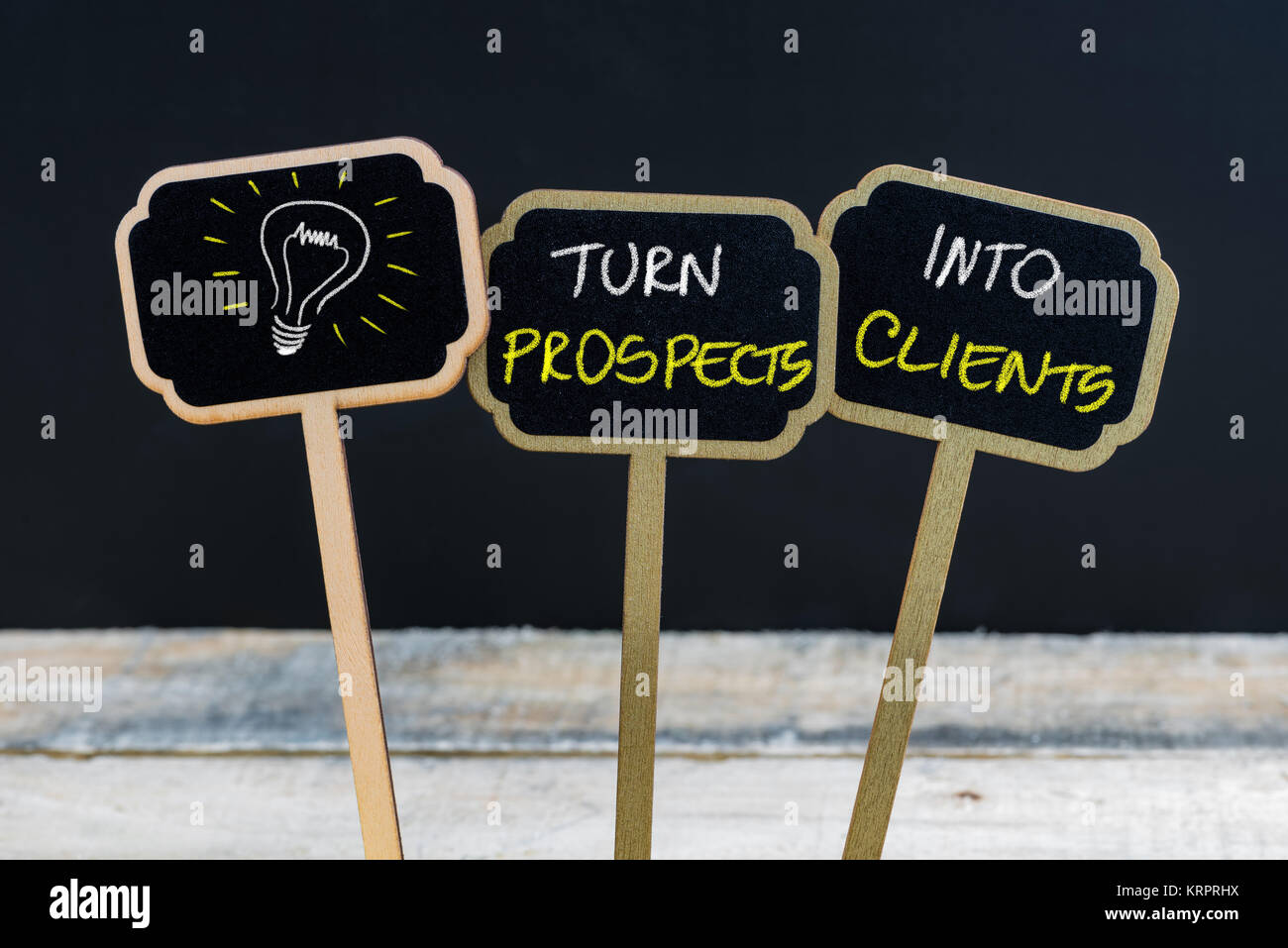 Concept message TURN PROSPECTS INTO CLIENTS and light bulb as symbol for idea Stock Photo