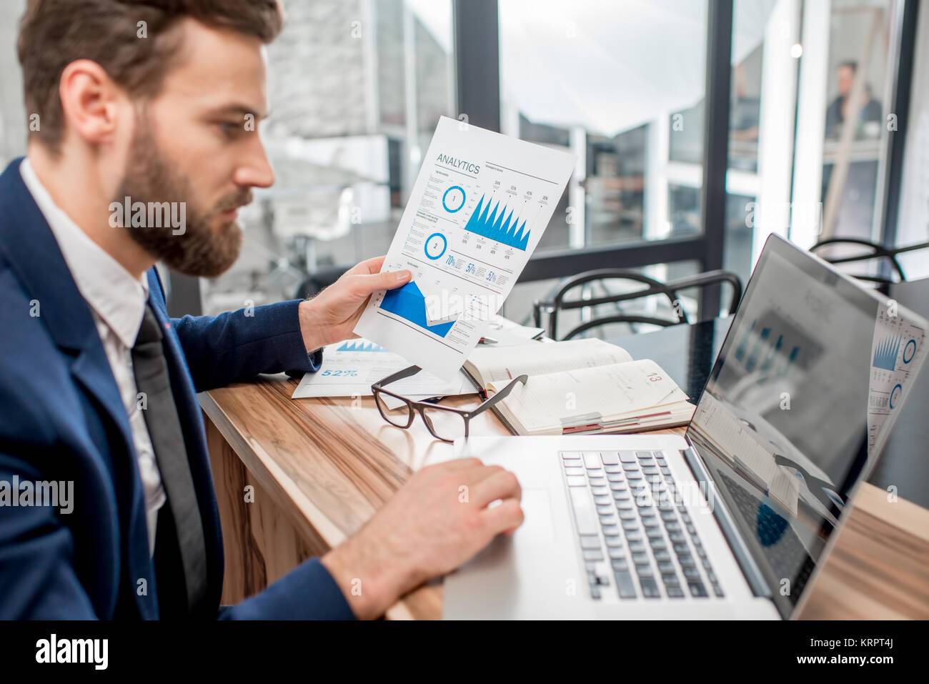 Analytic manager working at the office Stock Photo - Alamy