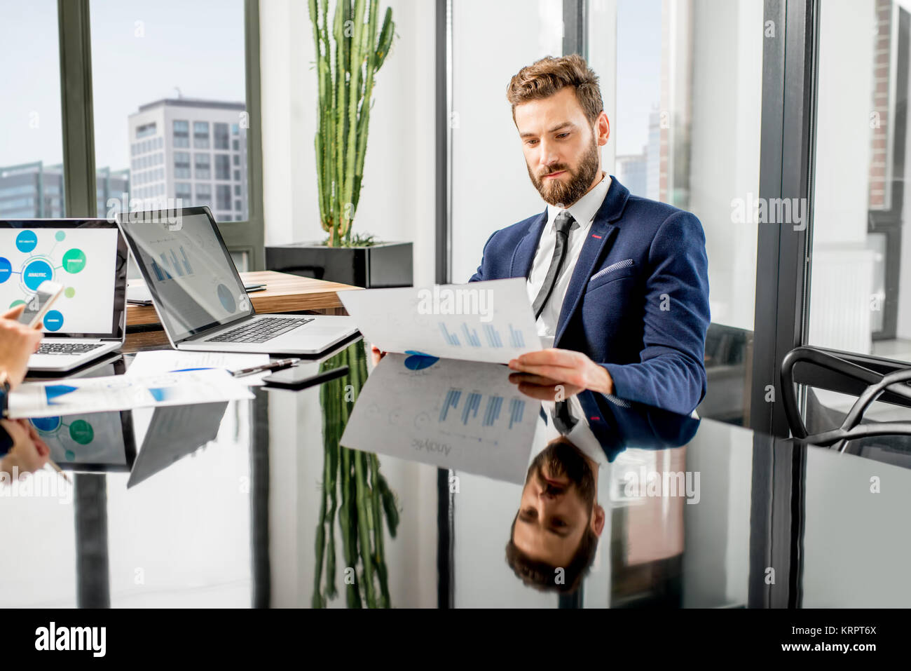 Analytic manager working at the office Stock Photo - Alamy