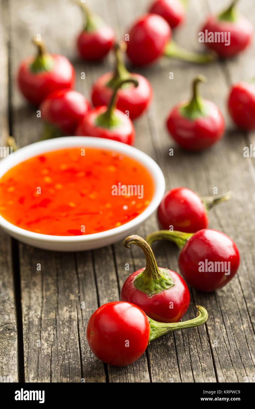 Red chili peppers and chili sauce. Stock Photo