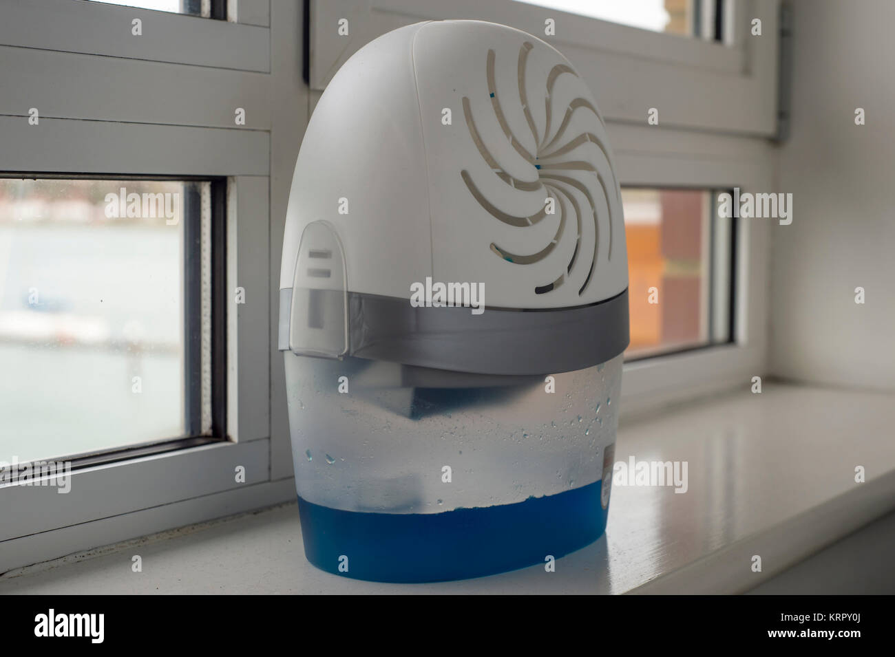portable dehumidifyer on a damp window sill Stock Photo - Alamy