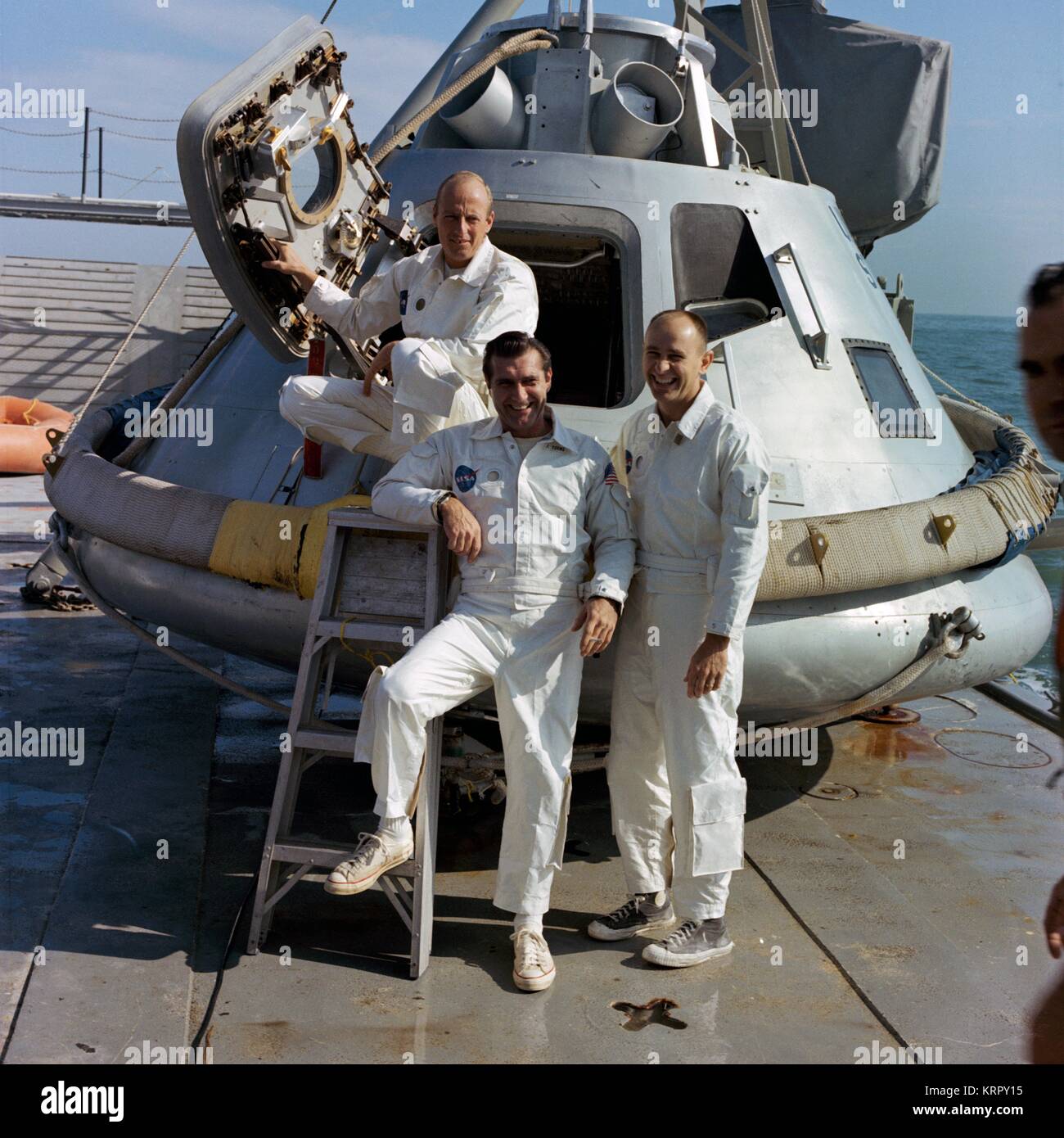 NASA Apollo 9 lunar orbital mission backup crew members American astronauts Charles Pete Conrad Jr. (left), Richard Gordon Jr., and Alan Bean stand on the deck of the Apollo command module trainer before water egress training November 5, 1968 in the Gulf of Mexico. Stock Photo