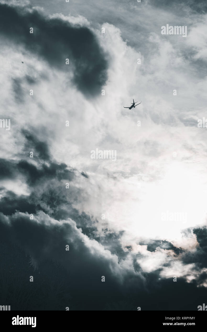 Aeroplane flying in a cloudy sky Stock Photo - Alamy