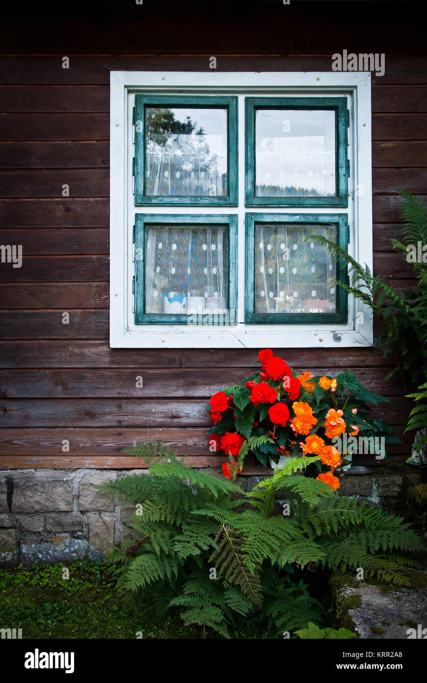 wall of wooden house with window and colorful flowers Stock Photo - Alamy