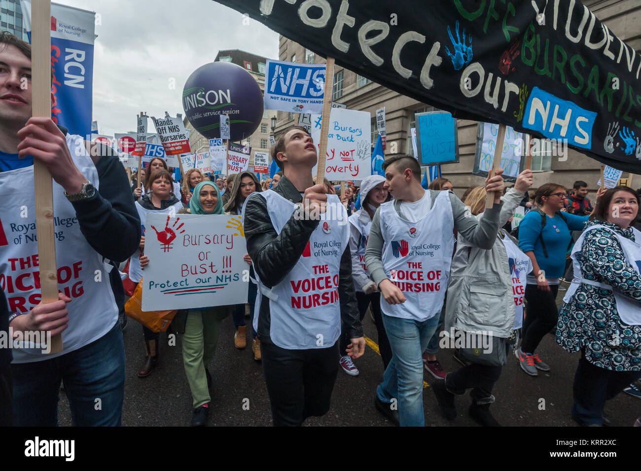 Men in Royal College of Nursing tabards carry a large banner on the march to save NHS Student Bursaries Stock Photo