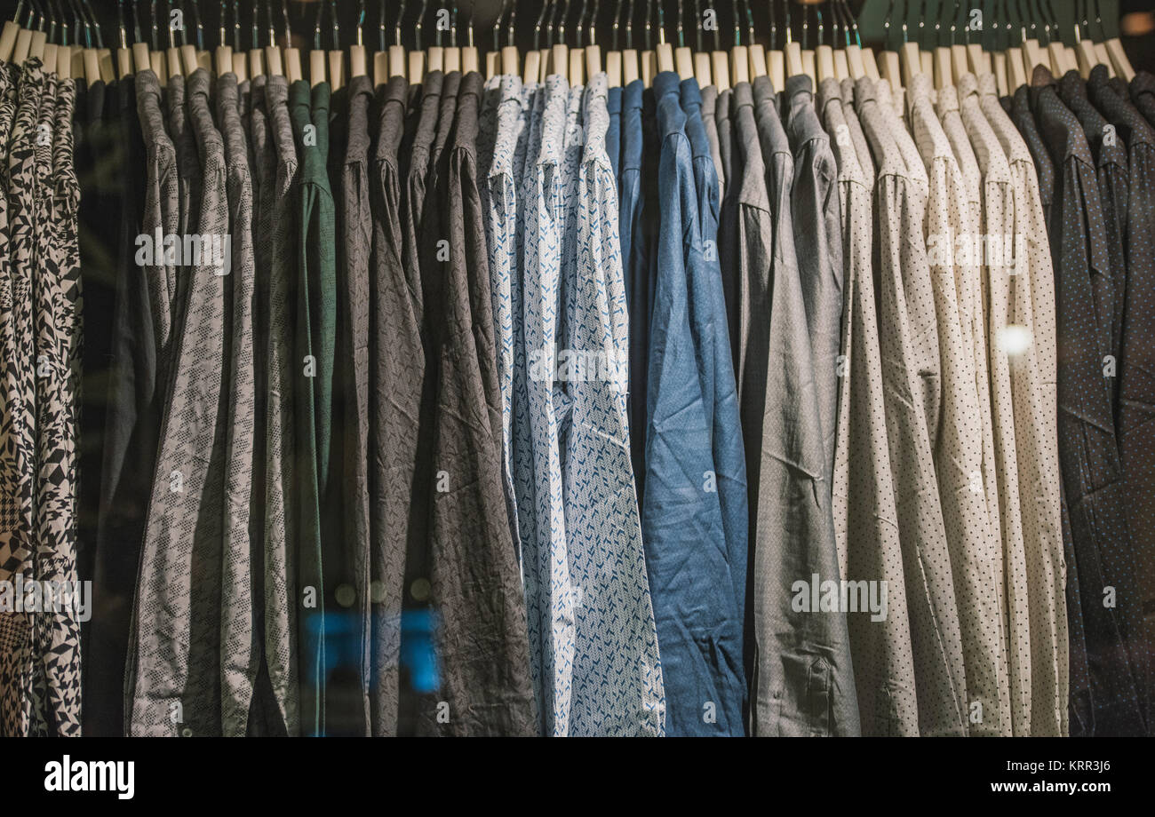 Vintage style image of male mens shirts on hangers in a shop display or  wardrobe closet rail Stock Photo - Alamy