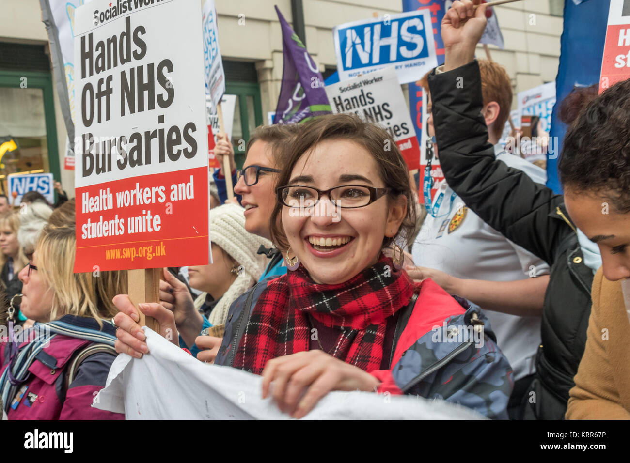 A woman holds a placard 'Hands Off NHS bursaries' before the march to save NHS Student Bursaries. Stock Photo