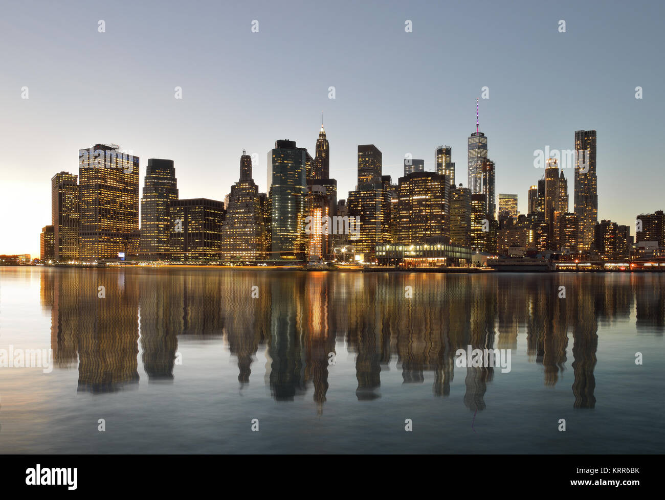 Manhattan skyline reflected in the water of the East River Stock Photo ...