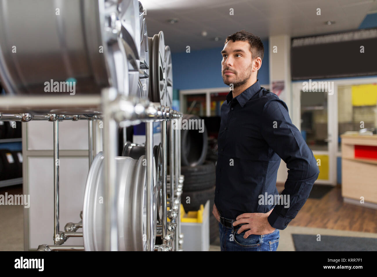 male customer choosing wheel rims at car service Stock Photo - Alamy