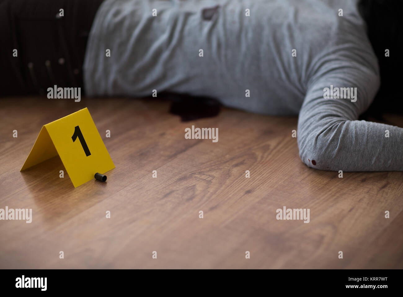 bullet and dead woman body on floor at crime scene Stock Photo