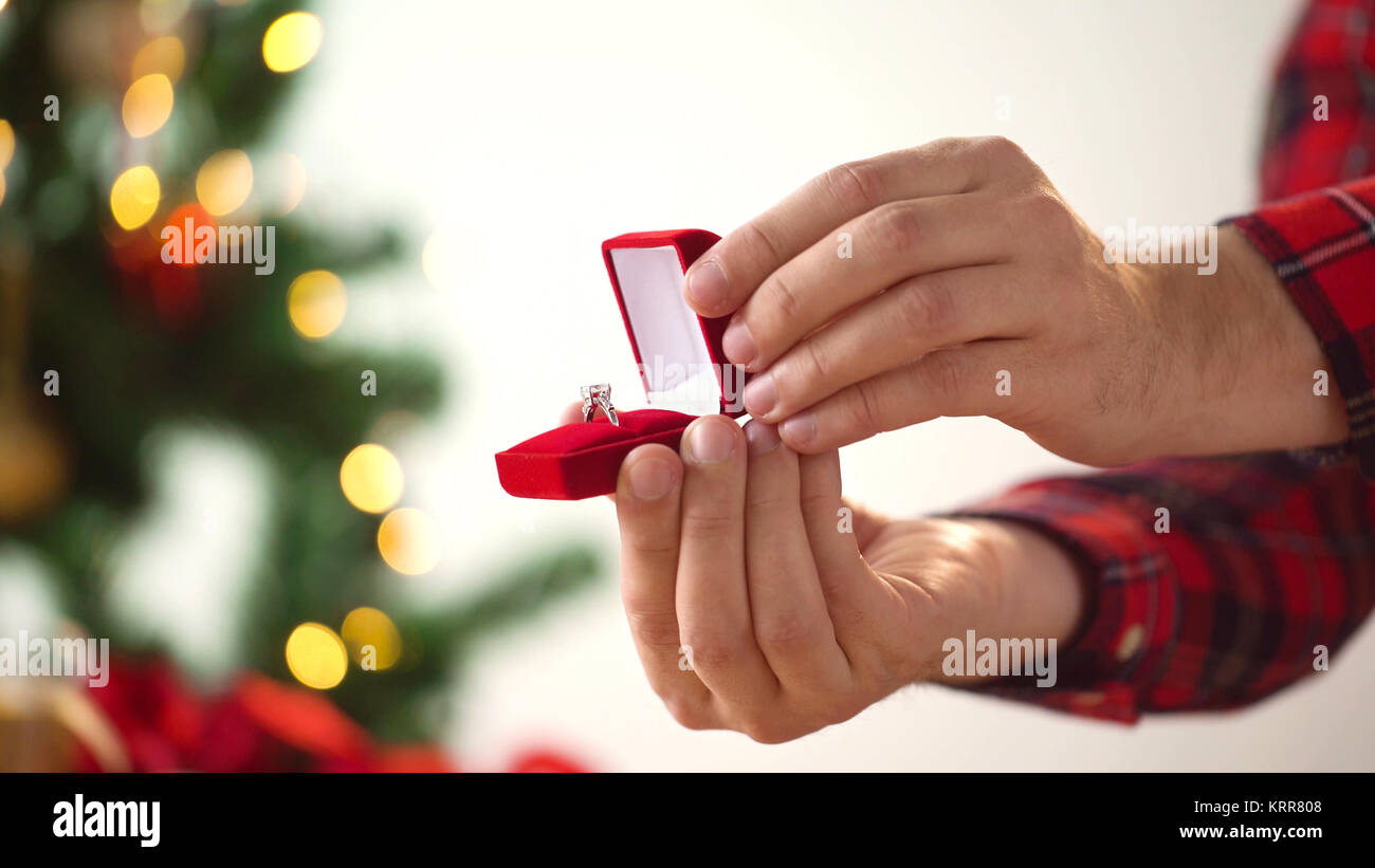 close up of hands with ring in christmas gift box Stock Photo