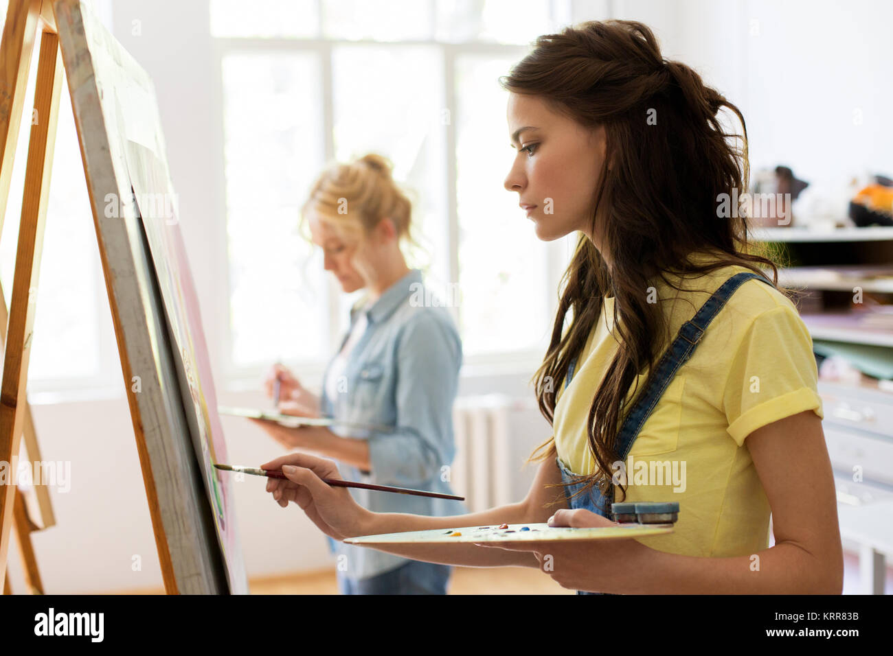 woman with easel painting at art school studio Stock Photo - Alamy