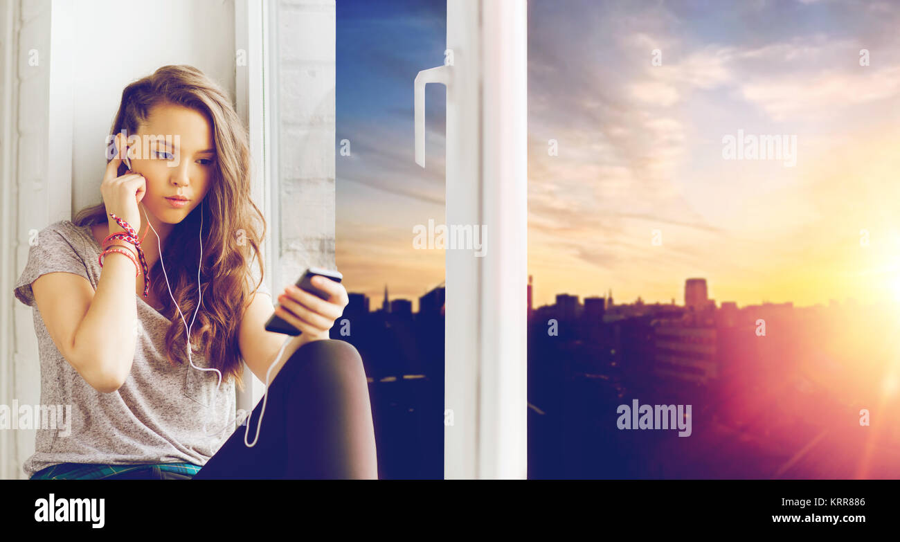 teenage girl with smartphone and earphones Stock Photo - Alamy