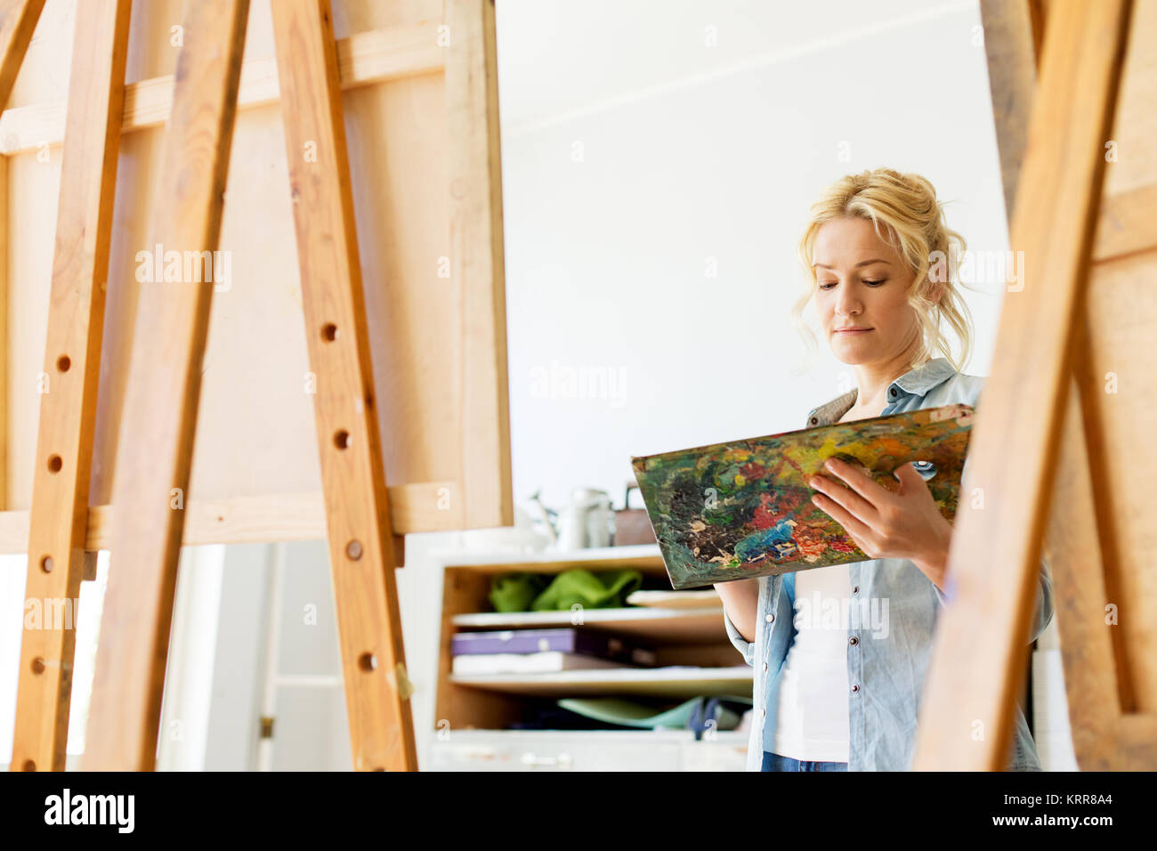 woman with easel painting at art school studio Stock Photo - Alamy