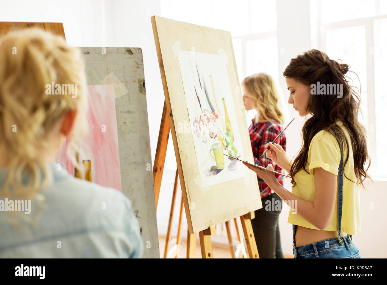 woman with easel painting at art school studio Stock Photo - Alamy