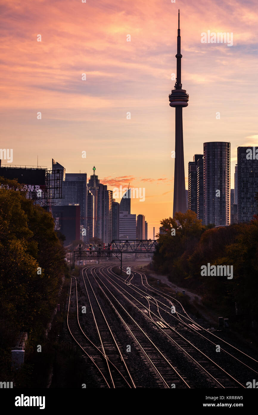 Train tracks leading toward sunrise in Toronto's downtown core Stock