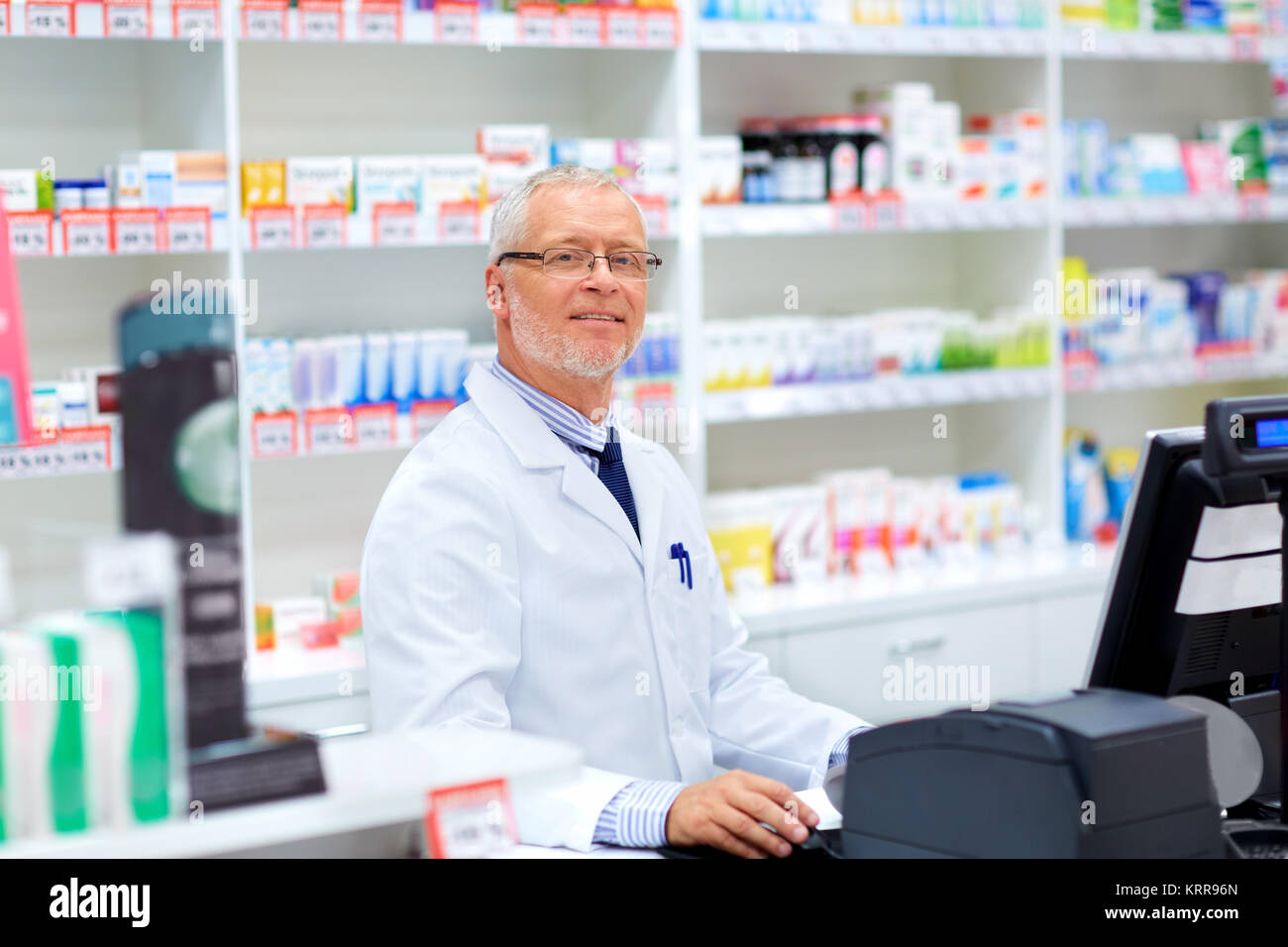 senior apothecary at pharmacy cash register Stock Photo - Alamy