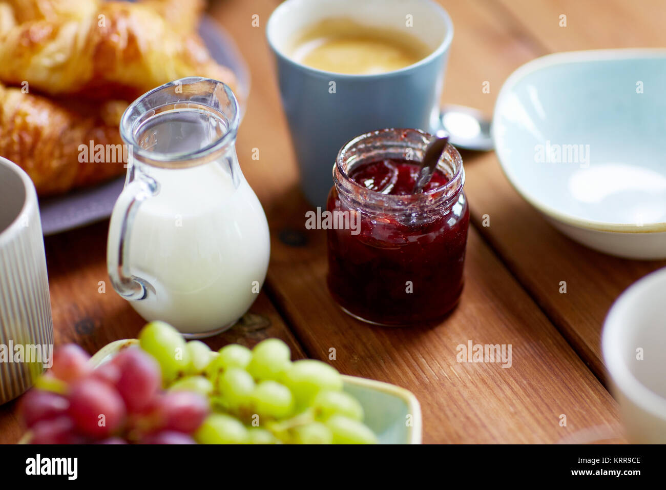 jar with jam on wooden table at breakfast Stock Photo