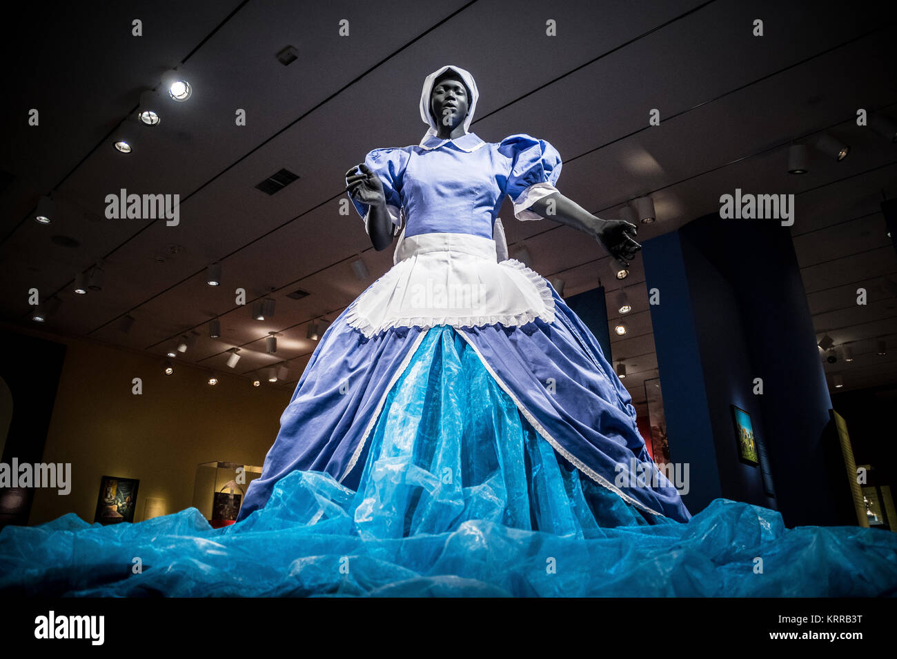 WASHINGTON, DC - A mixed media piece by South African artist Mary Sibande titled Sophie-Merica (2009). It combines the traditional blue uniform of domestic workers with a Cinderella-like gown that suggests indomitable imagination. It is on display at the Smithsonian National Museum of African Art in Washington DC. Located on the National Mall in Washington DC, the National Museum of African Art is the only national museum in the United States dedicated to the collection, exhibition, conservation, and study of the arts of Africa. Stock Photo