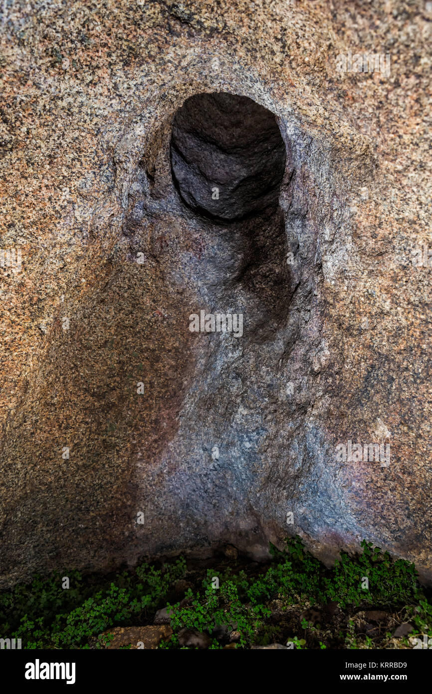 Cavity in a small cave in the natural area of the Barruecos (Spain). There are small remains of cave paintings, something common in caves in this area Stock Photo