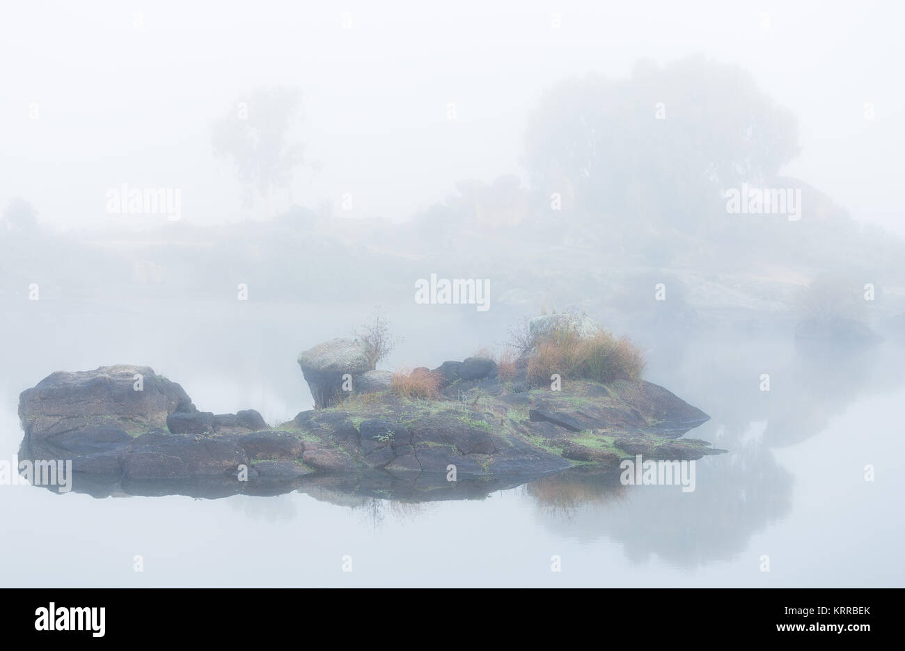 Landscape with fog in a lake. Landscape in the natural area of the Barruecos. Spain. Stock Photo