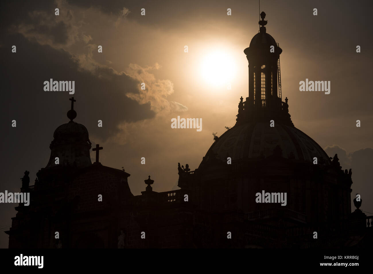 Silhouette of the rooftop of the Metropolitan Cathedral in Mexico City, outlined against the sun. Stock Photo