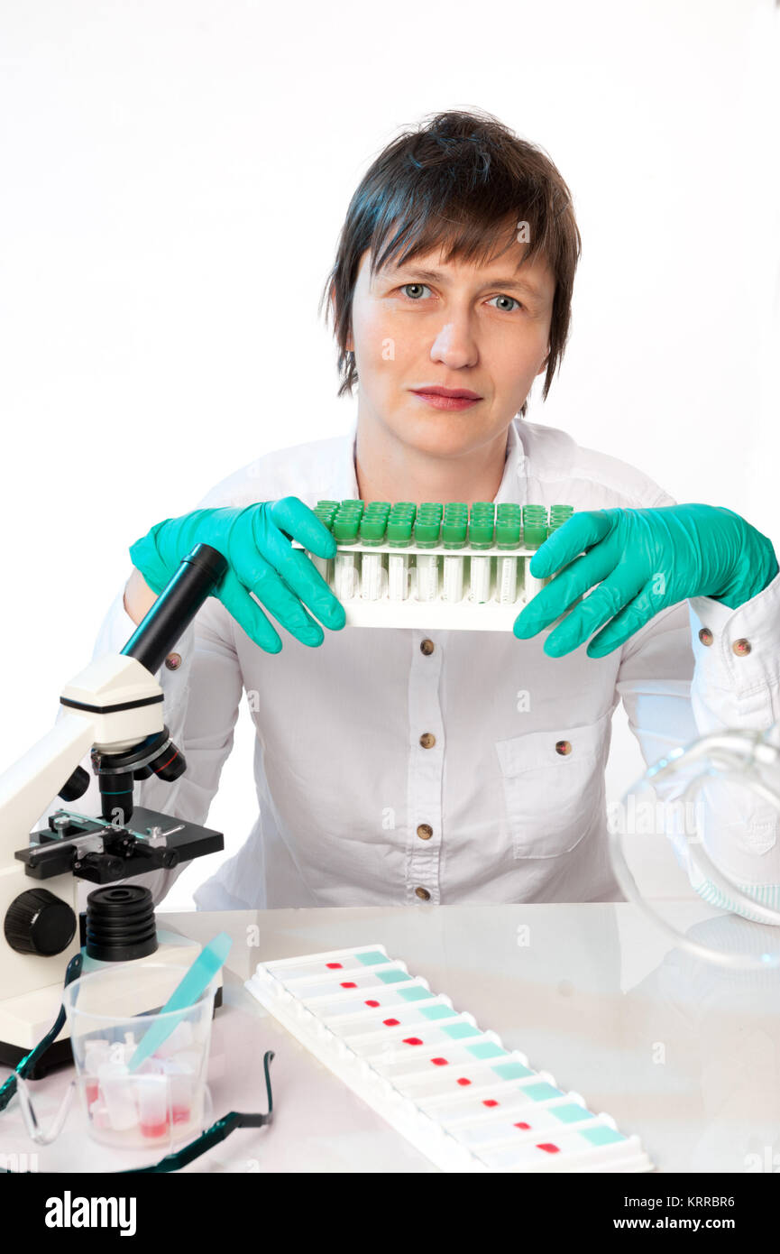 Histologist with a tube stand full of samples on a white background ...