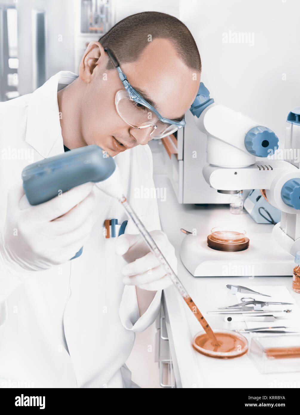 Young scientist in while lab coat works in the lab Stock Photo