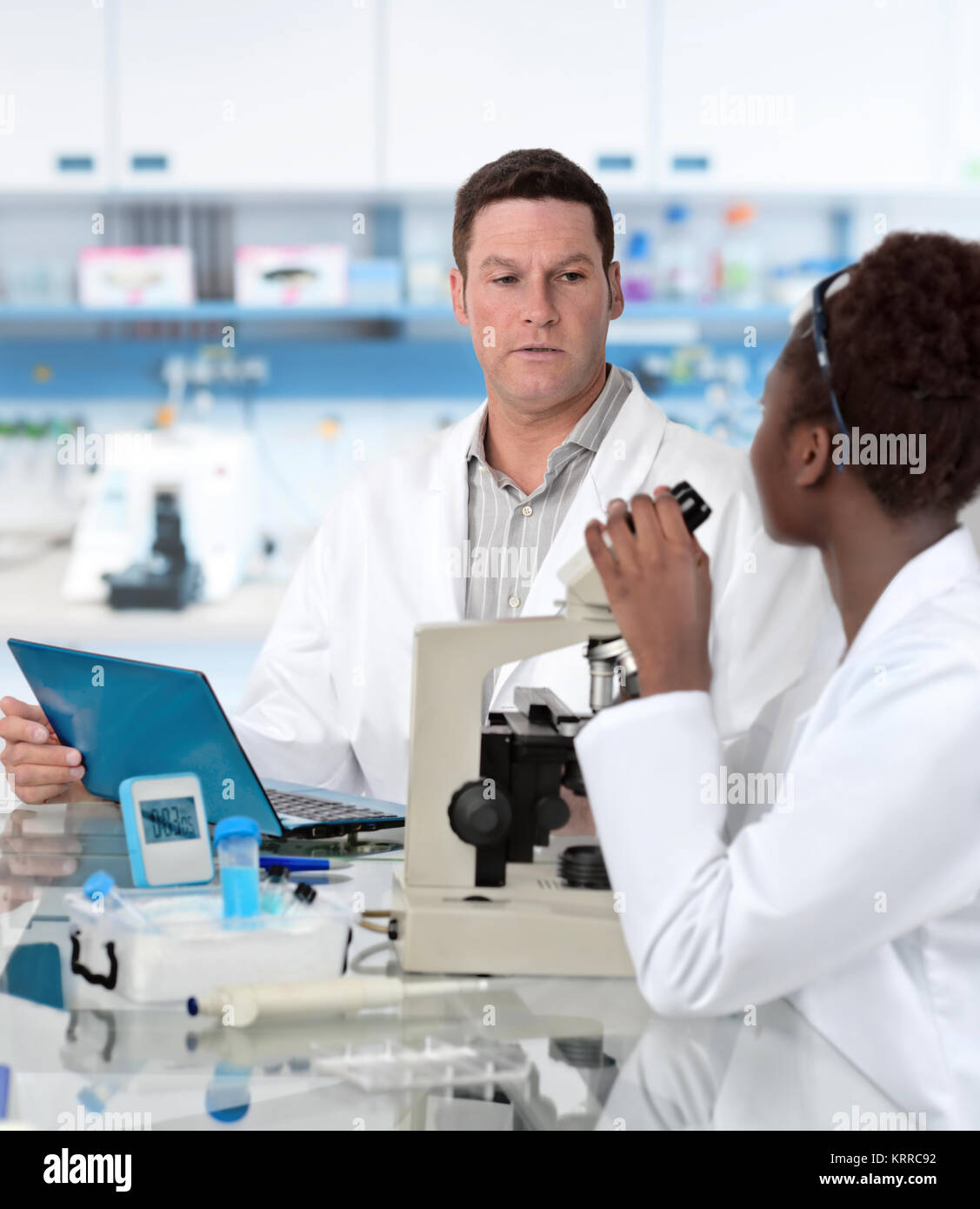 Senior scientist and graduate student work in histological lab Stock Photo
