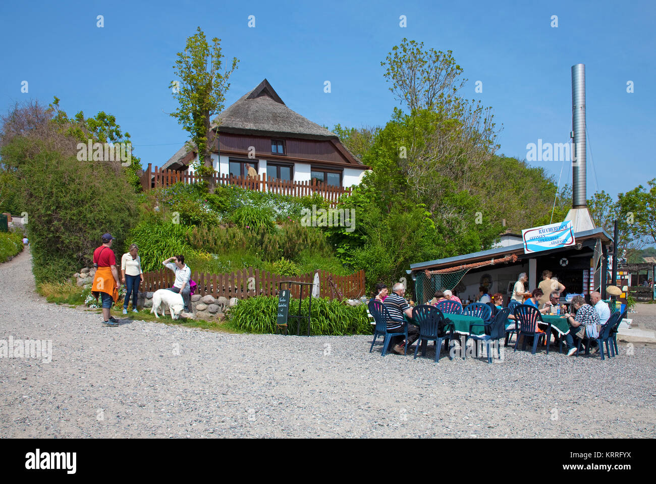 People at the beach of the village Vitt, Fish snacks at fish smoke house, Cape Arkona, North cape, Ruegen island, Baltic Sea, Germany Stock Photo