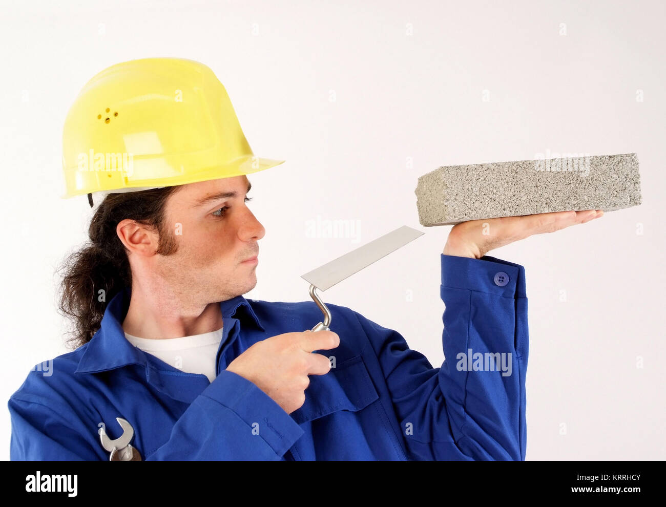 Bauarbeiter mit Blaumann, Bauhelm und Werkzeug - building worker with tools Stock Photo