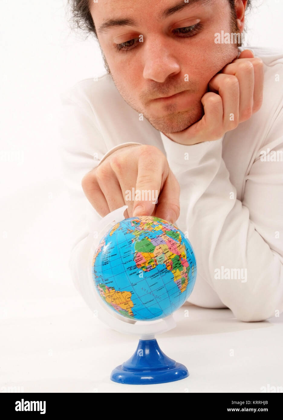 Junger Mann mit Miniatur-Globus - man with globe Stock Photo