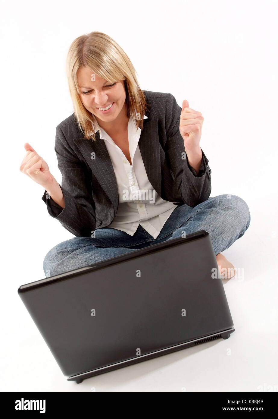Erfolgserlebnis am Laptop - successful woman using laptop Stock Photo