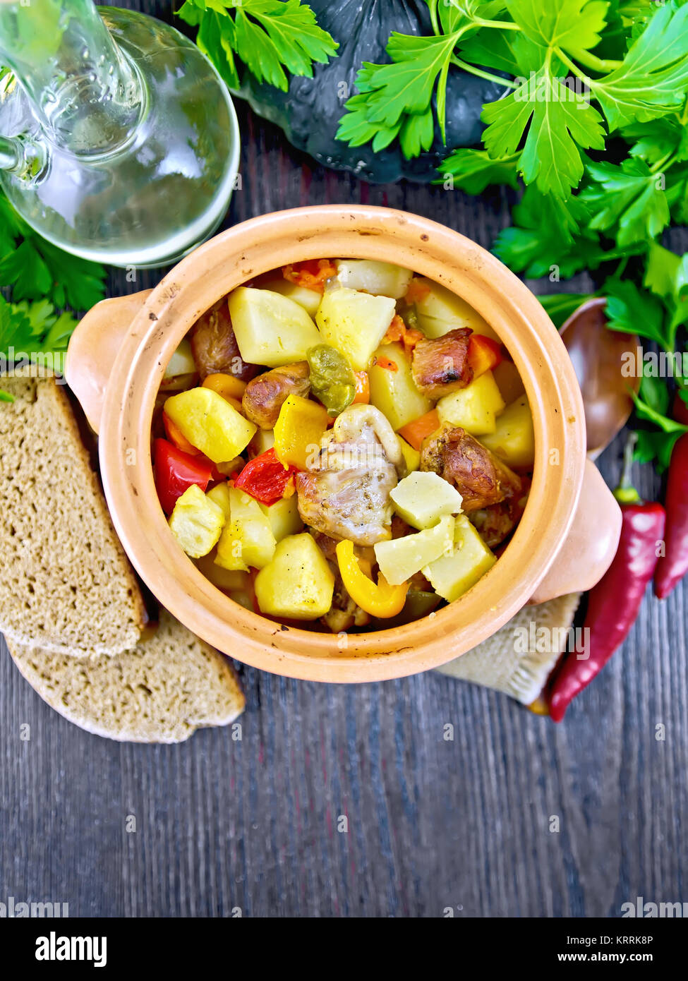 Roast meat and vegetables in clay pot on board top Stock Photo - Alamy