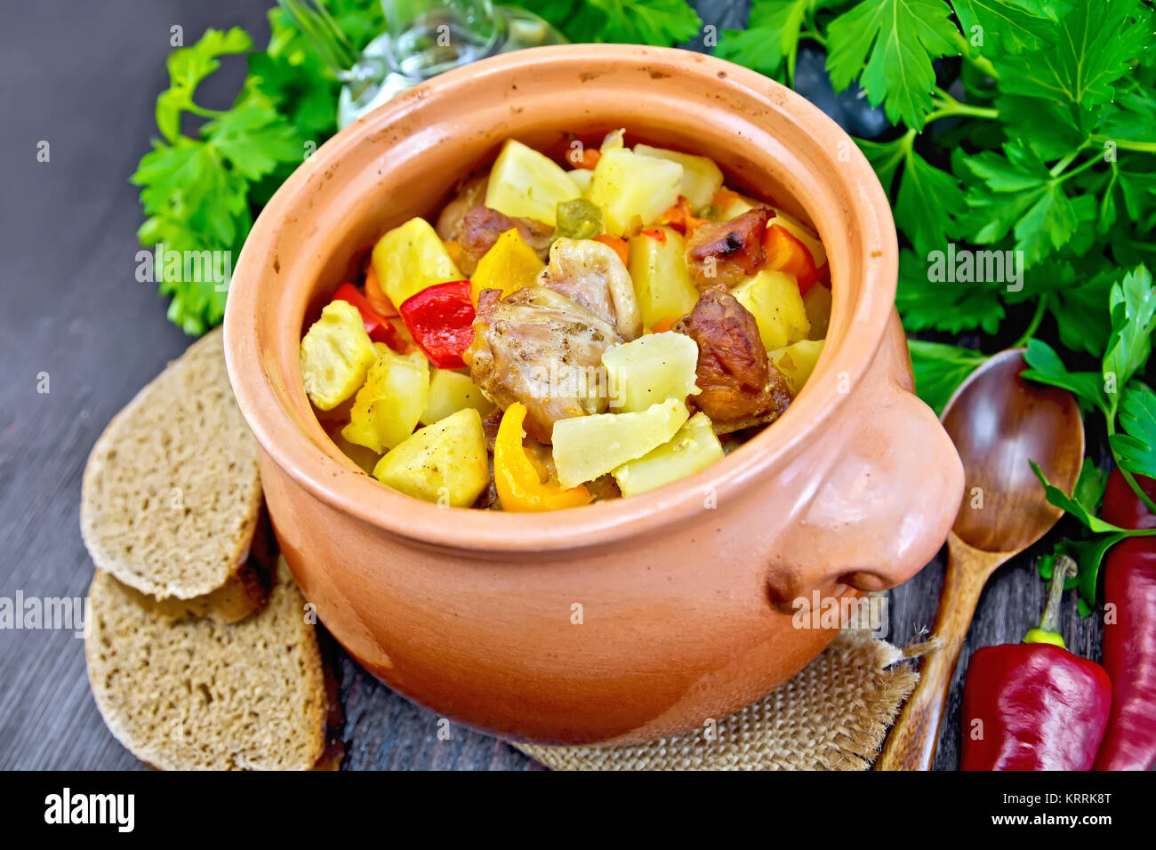 Roast meat and vegetables in clay pot on board Stock Photo - Alamy