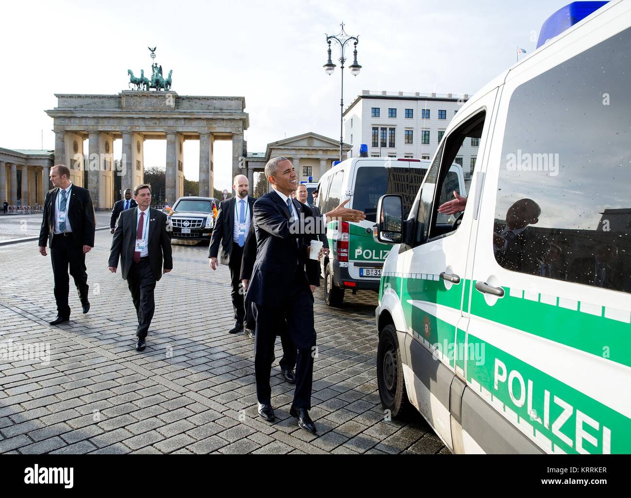 U.S. President Barack Obama greets local German police as he walks back to his hotel from the U.S. Embassy November 17, 2016 in Berlin, Germany. Stock Photo