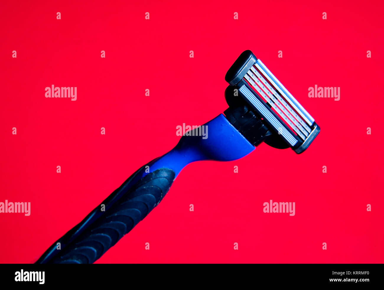 A razor with a new blade on a red background. Still life Stock Photo ...