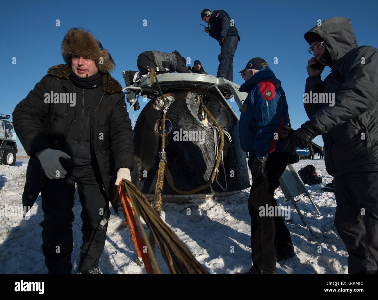 Russian Search and Rescue teams arrive at the Soyuz MS-05 spacecraft shortly after landing with NASA International Space Station Expedition 53 prime crew astronauts December 14, 2017 in Zhezkazgan, Kazakhstan. Stock Photo