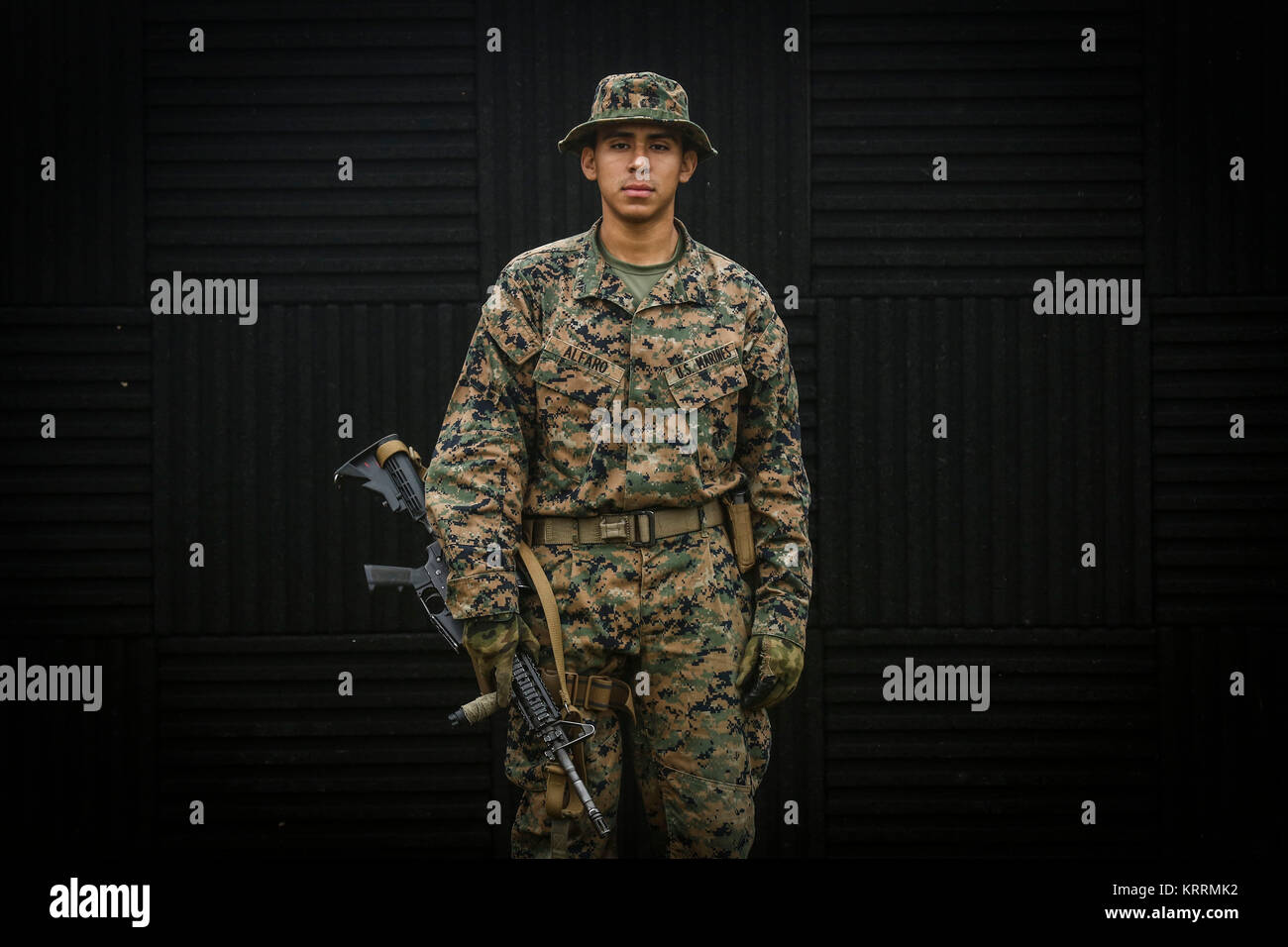 A U.S. Marine Corps soldier stand for a portrait with his rifle during the Marine Division Annual Squad Competition at Camp Hansen December 7, 2017 in Okinawa, Japan. Stock Photo